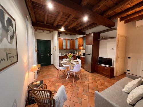 a kitchen and a living room with a table and chairs at CASA DI MILO in Cernobbio