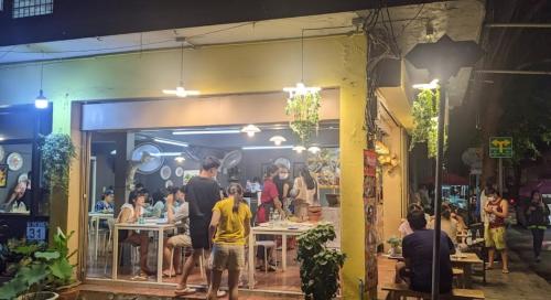 a group of people sitting at tables in a restaurant at Cozy home @ Chatcuchak/中文服务 in Bang O