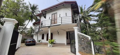 a house with a car parked in front of it at Thambara Resort in Polonnaruwa