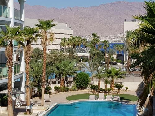 vista su un resort con piscina e palme di Palmore Top Luxury Resort First line of the Seaside a Eilat