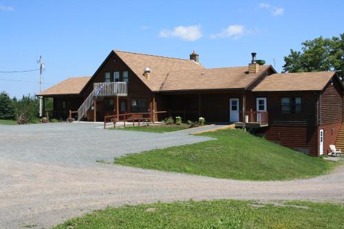 a large house with a driveway in front of it at Smith Rock Chalets in Scotsburn