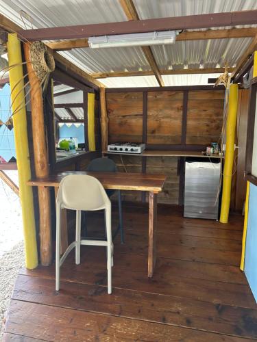 a wooden table and a chair in a room at Rangiroa Bliss in Tiputa