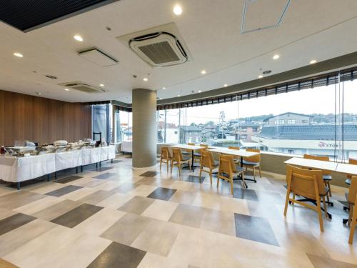 a dining room with tables and chairs and a cafeteria at Tokai City Hotel - Vacation STAY 83890v in Tokai