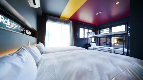 a bedroom with a large white bed in a room at Rakuten STAY x EAGLES in Sendai