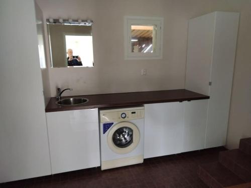 a kitchen with a washing machine and a sink at Talo 140 m2 in Siilinjärvi