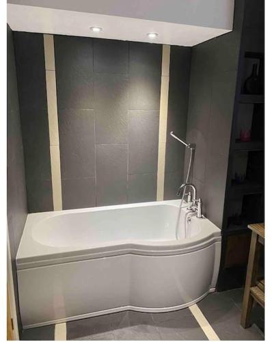 a white bath tub in a room with at Gwalia stores in Aberporth