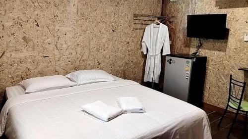 - une chambre avec un lit et 2 serviettes dans l'établissement ฟาดิลบังกะโล Fadel bungalow, à Ban Lo Pa Ret