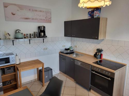 a kitchen with a sink and a counter top at Einzelwohnung im EG mit Terrasse und AC in Osterburg
