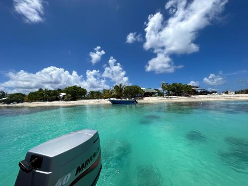 a boat in the water in front of a beach at Rangiroa Bliss in Tiputa