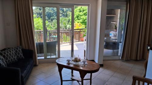 a living room with a coffee table in front of a sliding glass door at CHEZ LORNA 3 nights or plus in De Quincey Village