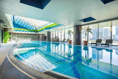 a large swimming pool in a building with a view at The Yokohama Bay Hotel Tokyu in Yokohama