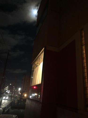 a building with the moon in the sky at tsubame-ya in Kyoto