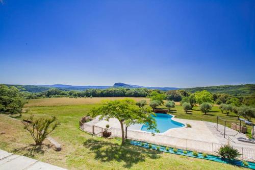 an estate with a swimming pool in a field at chambre d'hôtes in Rousson