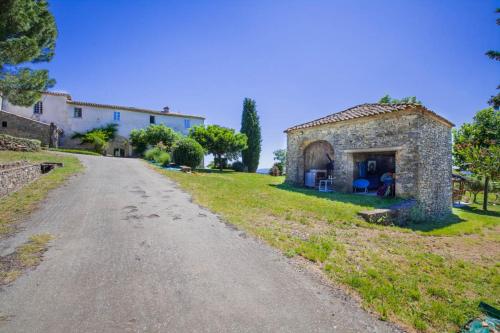 an old stone house on the side of a road at chambre d'hôtes in Rousson