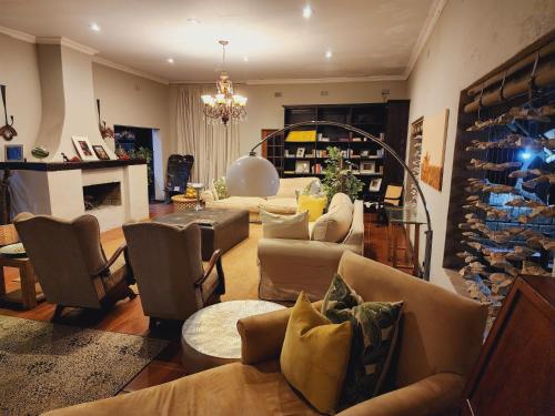 a large living room with couches and a fireplace at Karongwe Portfolio- Shiduli Private Game Lodge in Karongwe Game Reserve