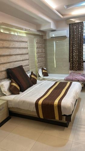 a bedroom with two beds and a window at Hotel CJ International in Amritsar