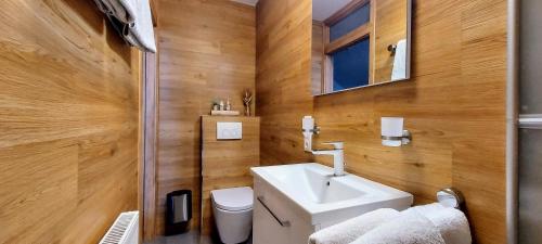 a bathroom with a white sink and a toilet at Waldhotel am Turm in Burgholz