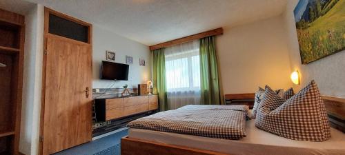 a hotel room with a bed and a television at Waldhotel am Turm in Burgholz
