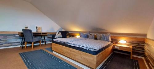 a bedroom with a bed and a desk and a table at Waldhotel am Turm in Burgholz