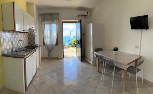 a kitchen with a table and a view of the ocean at Le Terrazze in Agropoli