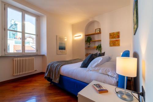 a bedroom with a bed and a desk and a window at Gerbett Apartment with Terrace by Wonderful Italy in Como