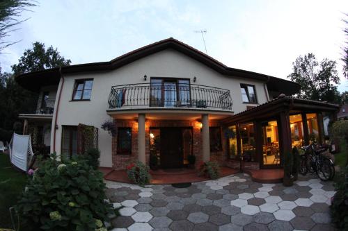 a large white house with a balcony at Willa u Wójta in Pobierowo