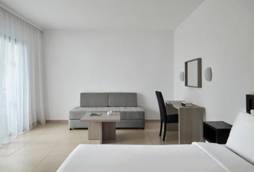 a living room with a couch and a table at Atlantica Callisto in Ayia Napa