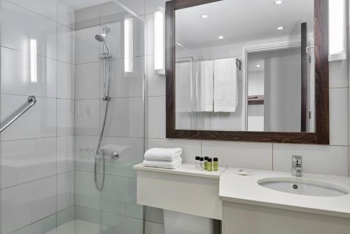 a bathroom with a shower and a sink and a mirror at Atlantica Callisto in Ayia Napa