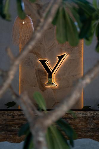a light with the letter y on a wall at Ycona Eco-Luxury Resort, Zanzibar in Dikoni