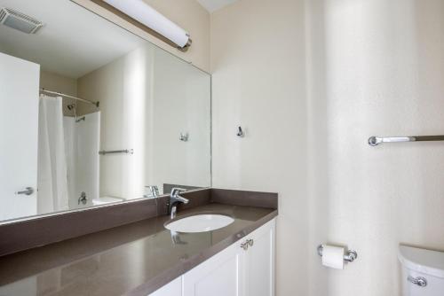 a bathroom with a sink and a mirror at La Jolla 1br w gym wd pool nr bars shops SAN-44 in San Diego