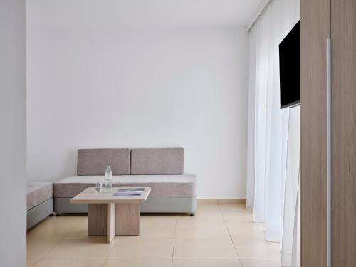 a living room with a couch and a table at Atlantica Callisto in Ayia Napa