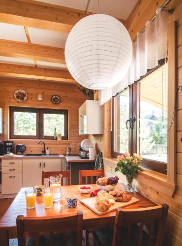 a kitchen with a table with food on it at Leśna 21 Dom Południe przy PUSZCZA BIAŁOWIESKA in Łuka