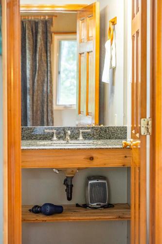 a bathroom with a sink and a mirror at Volcano Inn Bed n Breakfast in Volcano