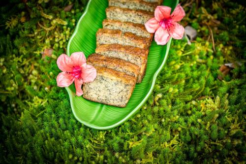 a green plate with a piece of bread with pink flowers at Volcano Inn Bed n Breakfast in Volcano