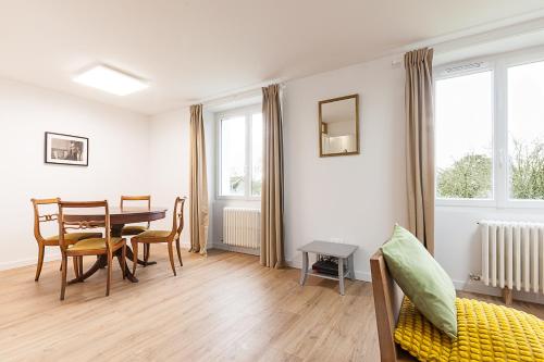 a living room with a table and a dining room at Sainte-Anne - Maison - Wifi - Parking in Sainte Anne d'Auray 