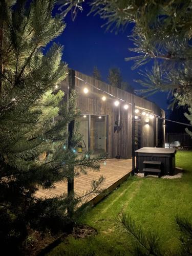 a house with a ping pong table in a yard at night at Sankakkei 2 - Lewy Brzeg Narwi in Burlaki
