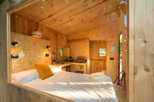 1 dormitorio con 1 cama en una casa de madera en Kampaoh Calella de Palafrugell en Palafrugell
