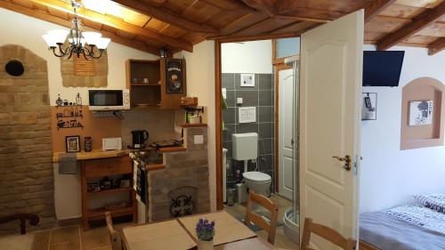 a small room with a bedroom and a bathroom at Mendei Vendégház - Deluxe Apartman in Mende