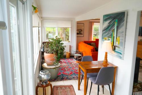 a living room with a table and a couch at Bijzonder chalet An der Marina met sauna in Anjum