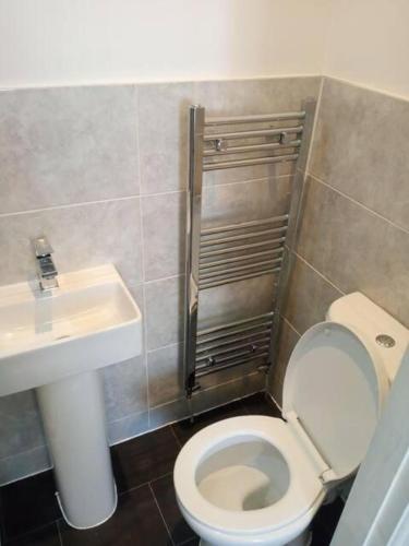 a small bathroom with a toilet and a sink at Double-bed (E1) close to Burnley city centre in Burnley