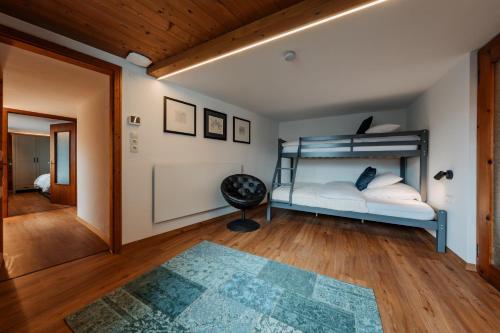 a bedroom with a bunk bed and a rug at Appartement Haus Honold in Schruns