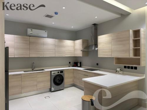 a kitchen with a washer and a washing machine at Kease Tawun B3-11 Royal touch Balcony AZ24 in Riyadh