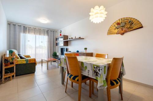 a dining room and living room with a table and chairs at Hauzify I Apartament Oliveres in Hospitalet de l'Infant