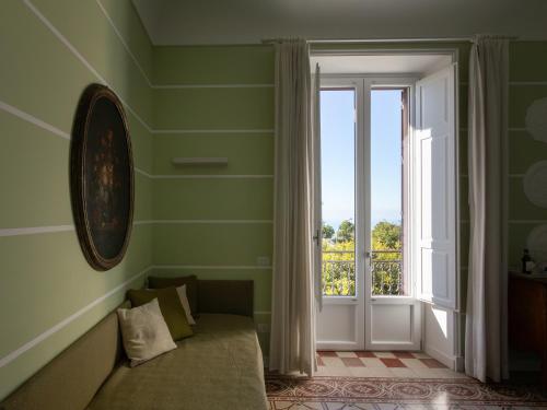 a room with a couch and a large window at Euterpe LHT in Agrigento
