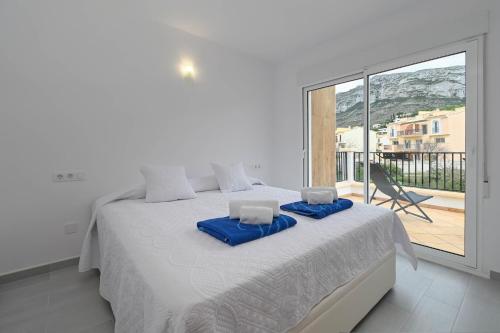 - une chambre blanche avec un grand lit et un balcon dans l'établissement Limoncello, à Dénia