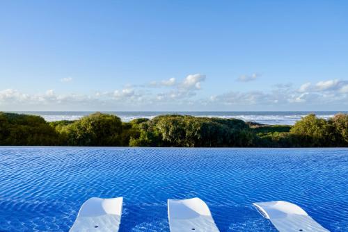 a pool of water with three dolphins in it at Pullman Mazagan Royal Golf & Spa in El Jadida