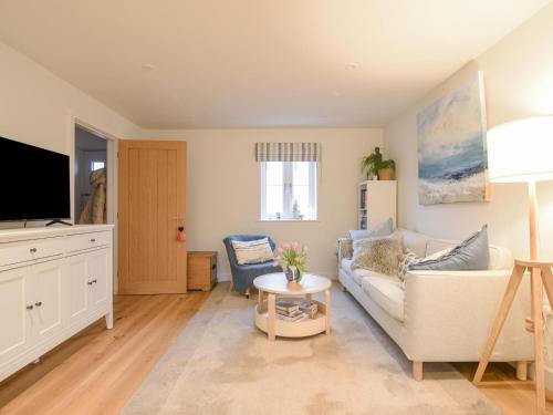 a living room with a couch and a tv at 22 Applebee Way in Lyme Regis