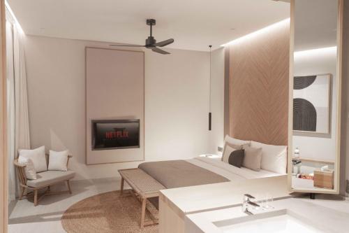 a bedroom with a bed and a tv and a sink at Sin Nombre Bali - Sauna, Ice Bath & Roof Terrace in Canggu