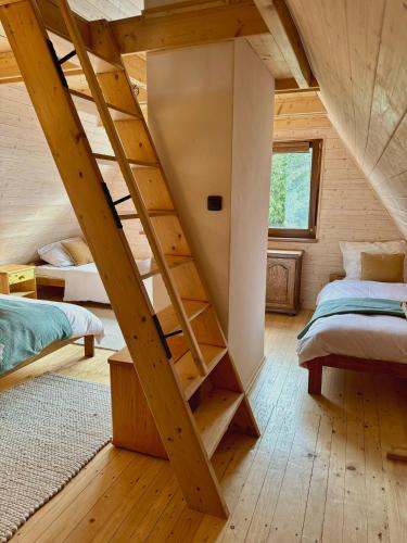 a room with stairs in a wooden house at Chata na Soláni in Vsetín
