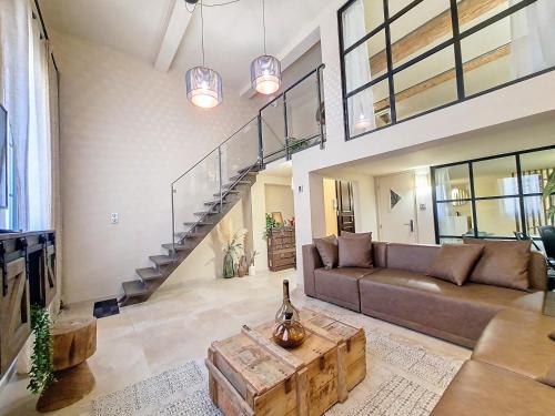 a large living room with a couch and a staircase at LOFT Centre Ville 2 Parking in Toulon